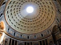 the inside of an old building with a dome and light coming from it's center window