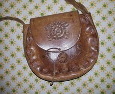 Beautiful vintage 70's hand tooled leather braided strap shoulder purse with pretty floral design.  Excellent, used condition.  8.5" wide, 8" tall, 2" deep & 21" from top of strap to bottom of purse.  Please let me know if you have any questions. Thank you. 70s Accessories Purse, Flowers Pretty, Owl Wall Art, 70s Hippie, Owl Wall, Hand Tooled Leather, Braided Strap, Tooled Leather, Purse Bag