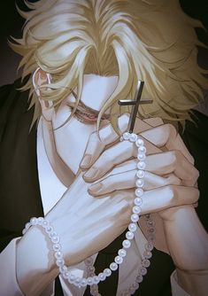 a man with blonde hair holding a cross in his hands and pearls around his neck