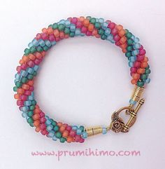 multicolored beaded bracelet with gold metal clasp and hook closure on white background