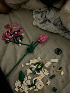 a pile of legos laying on top of a bed