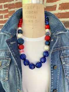 Red, white, and blue beaded statement necklace that's a real firecracker and ready to celebrate 4th of July with you. The perfect necklace to accessorize for a July 4th BBQ, Memorial Day, Military ceremonies, and other patriotic occasions. The necklace measures 26"L. Makes a great gift for a military mom or wife to accessorize for special patriotic military ceremonies or something special to treat yourself. Thanks for looking! Patriotic Blue Jewelry With Colorful Beads, Patriotic Blue Round Bead Jewelry, Patriotic Round Beads Necklace As Gift, Patriotic Round Beads Necklace Gift, Blue Jewelry For Independence Day Gift, Patriotic Blue Jewelry For Party, Patriotic Red Beaded Necklaces, Patriotic Blue Beaded Necklaces, Red Patriotic Necklace For 4th Of July