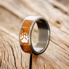 a wooden ring with an image of a dog's paw on it