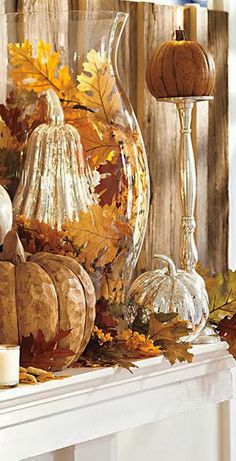 a mantle filled with pumpkins and gourds