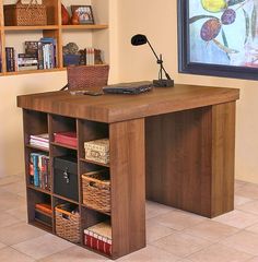 a wooden desk with drawers and a lamp on top