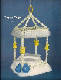 a baby crib mobile with blue shoes hanging from it's sides and the words paper diapers written below