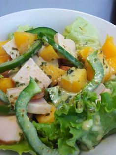 a white bowl filled with salad and vegetables