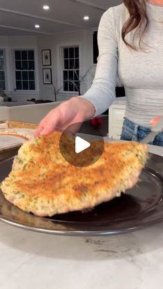 a woman is cutting up some food on a plate