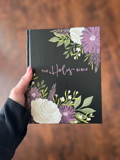 a person holding up a book with the words, the happy bible written on it