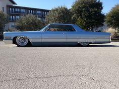 an old car is parked in a parking lot