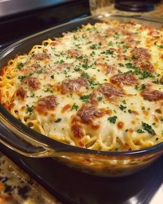 a casserole dish with cheese and pepperoni in it on a stove top