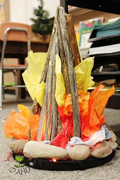 a pile of sticks sitting on top of a floor next to a bag filled with plastic bags