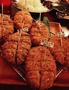 some fried food is sitting on top of a tray with chopsticks in it