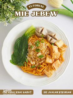 a white plate topped with noodles and vegetables on top of a table next to flowers