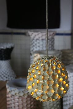 a light that is hanging from a wire with some lights in the shape of balls