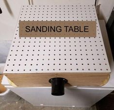 a sanding table with a sign that says sanding table on the front and bottom