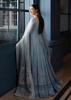 Readymade  Evoking the femininity of a sweeping silhouette, Miyah is a breath of fresh air. Fashioned from dainty net fabric in an ombré ice blue hue, the majestic pishwas showcases a myriad of heritage crafts such as resham and tilla, arranged with great attention to detail in a meticulous linear pattern. Paired with a silk churidaar and an embroidered organza dupatta, this piece is sure to make heads turn at every event. What's Included: Embroidered Bodice Front + Back (Net) 1 PairEmbroidered Sleeves (Net) 1 PairEmbroidered Shirt Panels (Net) 16 PiecesEmbroidered Panel Motifs (Net) 16 PiecesEmbroidered Panel Border (Organza) 4.2 Meters Embroidered Dupatta Center (Organza) 1.5 MetersEmbroidered Dupatta Side Border (Organza) 7 MetersEmbroidered Dupatta Pallu 1 (Organza) 2 MetersEmbroidered Faiza Saqlain, Dupatta Style, Frock Style, Semi Formal Wear, Pakistani Wedding Dress, Lace Accessories, Heritage Crafts, Chiffon Collection