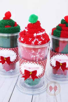 three cups filled with red and green cupcakes