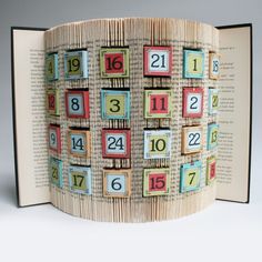 an open book with numbers on it and the pages are folded to look like a page