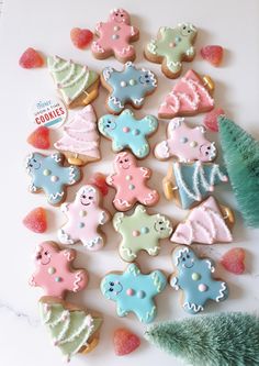 decorated cookies arranged in the shape of christmas trees and other holiday decorations on a white surface