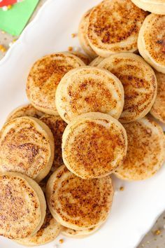 there are some pancakes on a plate with cinnamon sprinkles around the edges