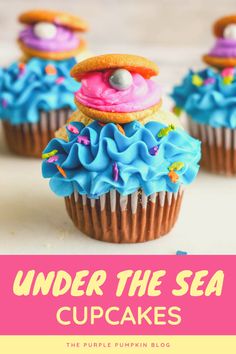 some cupcakes with blue icing and pink frosting on top are in front of the words, cute and easy clam shell cupcakes