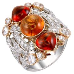 Three round cabochon spessartite garnets totaling more than 10.13-carats in varying shades of orange shine brightly on this 18k white gold and palladium ring paved with 0.80-carat diamonds and 1.50-carat of white sapphires. This ring, as with all Zorab Creation pieces, is sent with a unique serial number to validate its authenticity. Ring Size 7 Luxury Orange Diamond Jewelry, Luxury Orange Rings With Accent Stones, Luxury Fine Jewelry In Orange, Luxury Orange Jewelry For Ceremonial Occasions, Luxury Orange Diamond Ring For Formal Occasions, Luxury Orange Diamond Ring For Formal Events, Luxury Orange Ring With Center Stone, Luxury Orange Fine Jewelry, Luxury Exquisite Orange Jewelry