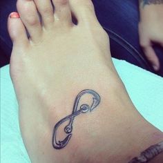 a woman's foot with a tattoo on it that is shaped like an infinite knot