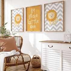 a living room with three framed pictures on the wall and a wicker chair next to it