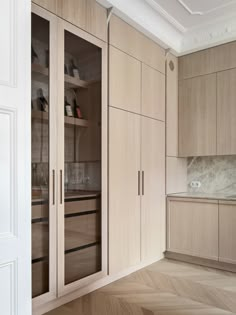 an empty kitchen with wooden cabinets and marble counter tops, along with wood flooring