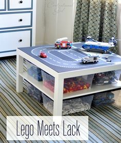 a toy table with cars and trucks on it in a child's playroom