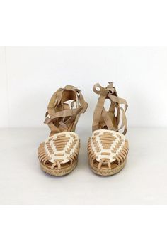 Slip into these romantic wedges. Designed with a ribbon lace-up style and woven front. Espradrille wedge heels gives them a unique touch. Size 6 Leather upper Rubber sole Ribbon lace-up style Espradrille heel Woven front Light outsole wear Heel height 2.75" Casual Lace-up Wedge Sandals With Woven Sole, Beige Leather Lace-up Sandals With Round Toe, Adjustable Lace-up Platform Wedge Sandals, Beige Round Toe Wedge Sandals With Woven Sole, Casual Lace-up Wedge Sandals With Wrapped Heel, Adjustable Lace-up Wedge Sandals For Beach, Beige Closed Toe Leather Lace-up Sandals, Natural Wedge Sandals With Woven Sole And Round Toe, Beige Leather Closed Toe Lace-up Sandals