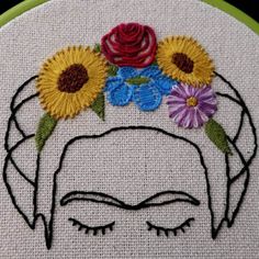 a woman's face with flowers in her hair