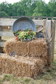 hay bales stacked on top of each other with flowers in the middle