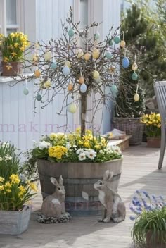 an outdoor area with potted plants and easter decorations