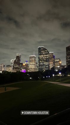 the city skyline is lit up at night in this time lapse photo from downtown houston