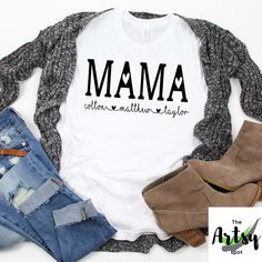 a t - shirt with the words mmm written in black on it, next to ripped jeans and booties