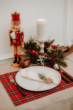 a white plate topped with a napkin next to a nutcracker figurine