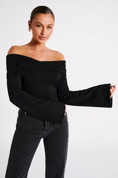 A bare essential.MARLISSA is a long-sleeved, off-shoulder top with a twisted fabric neckline and bodycon fit. It also features a low, open back with adjustable sliders for a better, more custom fit. The fabric panel along the neckline twists at the back and centre, adding to the visual texture. The torso is fitted while the sleeves are long and flared, creating a balanced silhouette. Pair with fitted jeans like our Tina Mom Jeans for an easy day look. FEATURES: Off shoulder neckline Front overla Luxury Long Sleeve Top For Night Out In Fall, Luxury Tops For Date Night In Fall, Sleek Fall Tops, Basics Clothing, Wife Clothes, Twisted Fabric, Fitted Jeans, Dresses Date Night, Twist Top