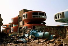 a bunch of buildings that are next to each other in the dirt and rubble with trash on the ground