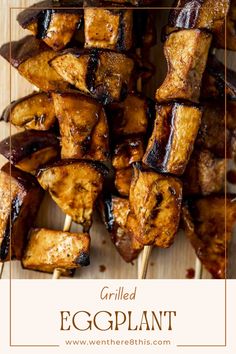 grilled eggplant skewers on a wooden board with text overlay