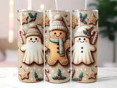 three frosted cups decorated with gingerbreads and snowmen