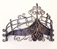 an ornate metal mask hanging on the wall