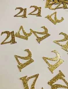 gold glitter numbers are arranged on a white surface