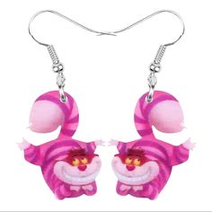 a pair of pink and white earrings with an animal on the front, one is wearing a