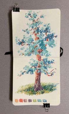 a drawing of a tree with birds flying around it on a piece of white paper