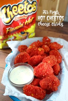 some food is sitting on a table next to a bag of cheetos