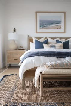 a bedroom with a large bed and blue pillows