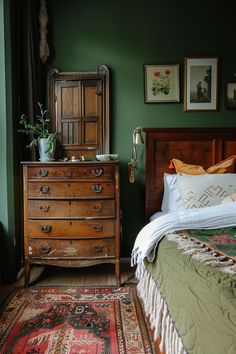 a bed room with a neatly made bed and a wooden dresser next to the bed