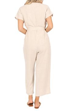 A defining tie tethers the waist of this lightweight linen jumpsuit designed with abbreviated sleeves and cropped legs. Front button closure V-neck Short sleeves Removable belt Side patch pockets 100% linen Hand wash, dry flat Imported Beige Linen Casual Jumpsuits And Rompers, Chic Beige Linen Jumpsuits And Rompers, Chic Linen Jumpsuits And Rompers With Short Sleeves, Relaxed Fit Linen Jumpsuit With V-neck, Spring Linen Jumpsuits And Rompers For Work, Relaxed Fit Linen Jumpsuits And Rompers With Short Sleeves, Fitted Linen Jumpsuits And Rompers With Pockets, Relaxed Fit Linen Short-sleeved Jumpsuit, Relaxed Fit Linen Jumpsuit With Short Sleeves